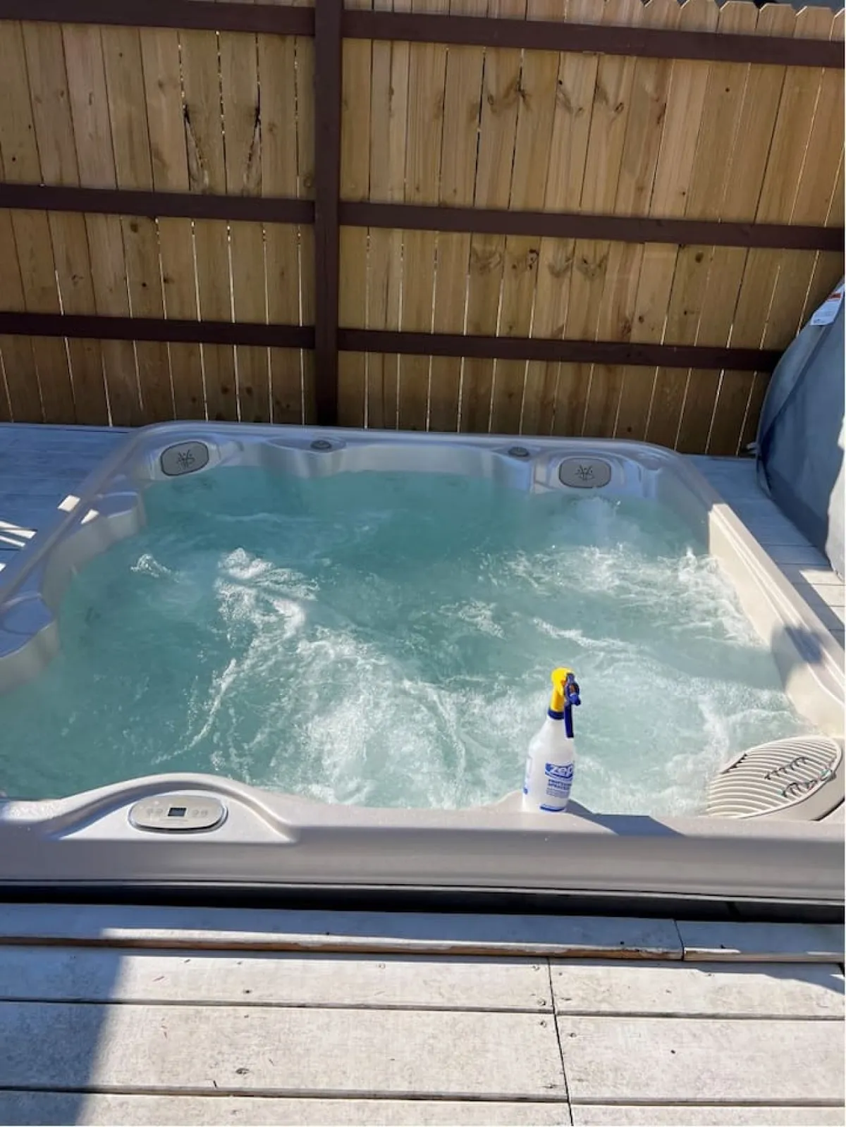 A cozy indoor hot tub filled with clear water, ready for a tranquil soak. The space feels private and inviting, ideal for relaxation and unwinding after a day of activities.